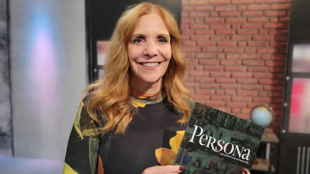 Associate Publisher Laura Wrasman holds up a copy of Persona Naperville Magazine.