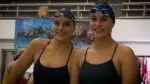 Piater Twins smile and stand next to pool as they share success.