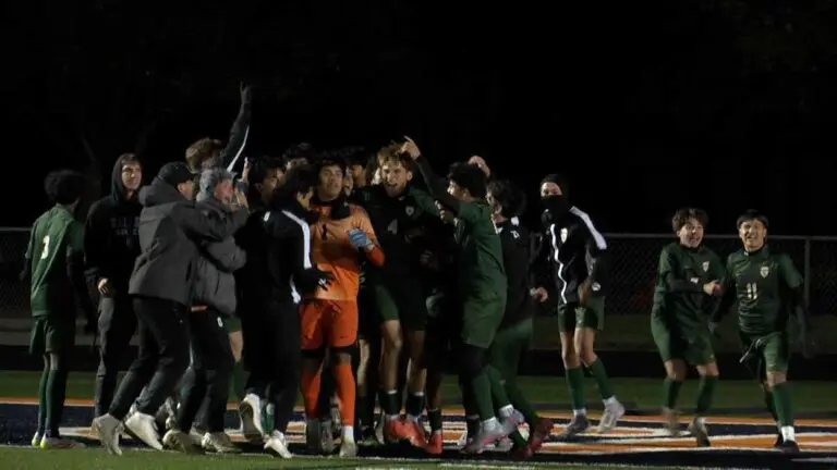 Waubonsie Boys Soccer earns victory as their players celebrate.