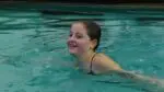 Ella Bucenhauer’s inward somersault tuck was successful as she swims in the pool.