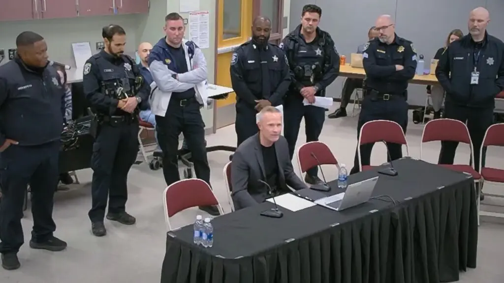 Group of school resource officers standing behind table at IPSD 204 meeting