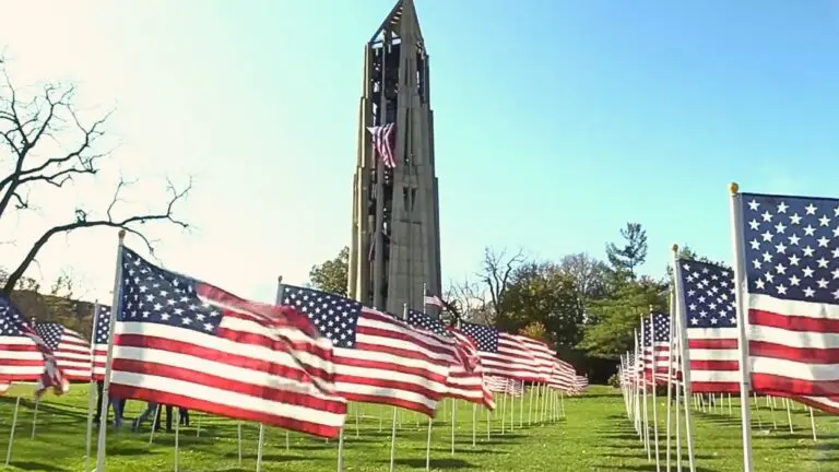 Flags from the Healing Field of Honor wave on Rotary Hill with Moser Tower in the background