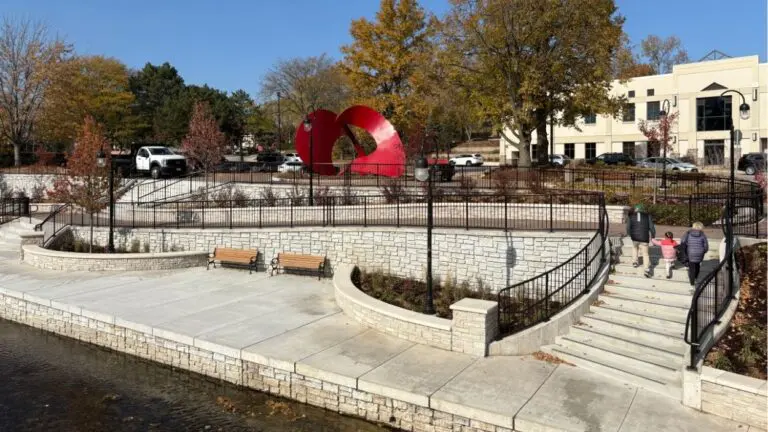 Wide view of new Eagle Street Gateway along Naperville Riverwalk with family walking up the stairs
