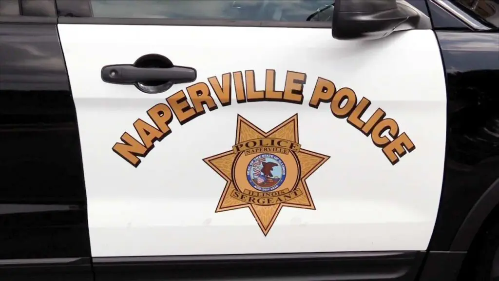Close up of Naperville Police words and badge symbol on side of squad car