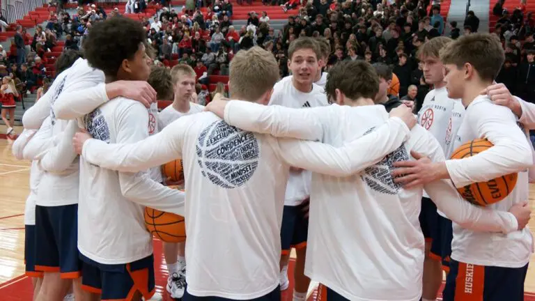 Naperville North North boys basketball uses a moment to remain huddled up to take on Naperville Central
