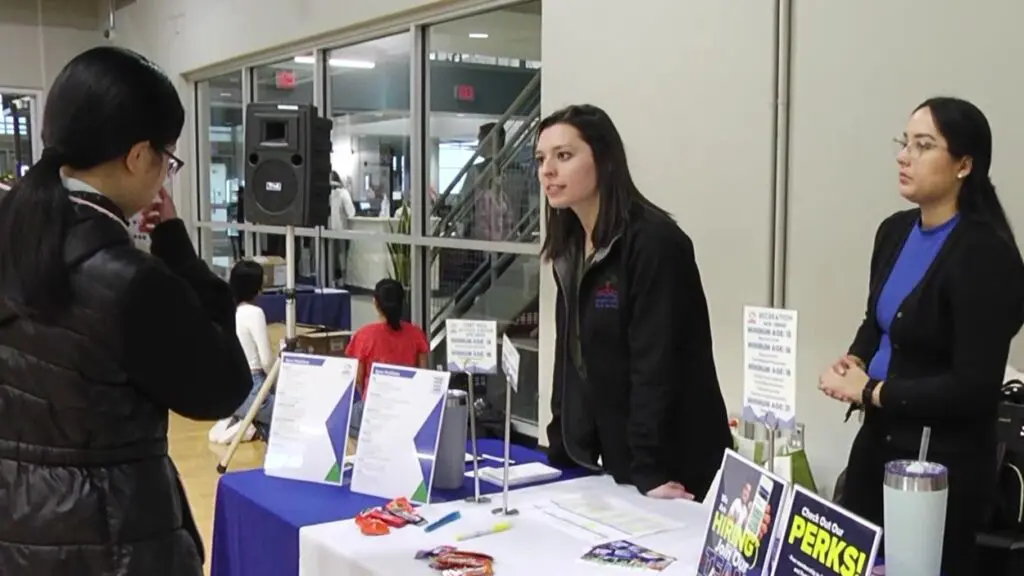 Employers at a table to speak with attendees at the Community Job Fair.