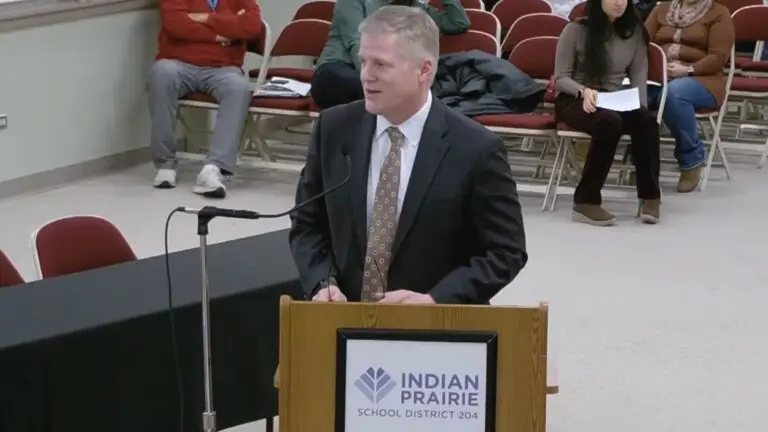 Dr John Price the new IPSD 204 superintendent standing at podium at board meeting