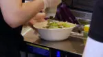 close up of a bowl being made at Naperville's new CAVA fast-casual dining restaurant