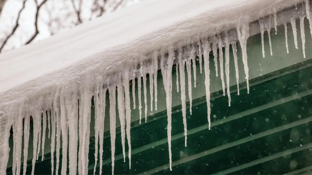 The image shows icicles forming on the side of a roof, as dangerously cold temperatures are head for Naperville.