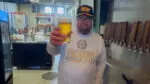 Solemn Oath Brewery founder John Barley toasting a beer