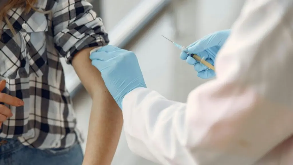 A patient gets a shot of at the doctors office, as flu cases surge statewide in Illinois.