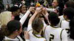 Waubonsie Valley girls basketball celebrates together after victory