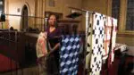 Connie Martin stands next to quilts etched with codes used in the underground railroad.
