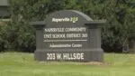 Close up of Naperville District 203 administration buildling sign for story on board president addressing circulating claims