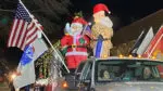Float from 2025 Holiday Parade of Lights in Naperville featuring blowup of Santa Claus