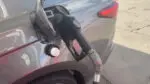 A gas pump rests inside a car's fuel tank at a Naperville gas station