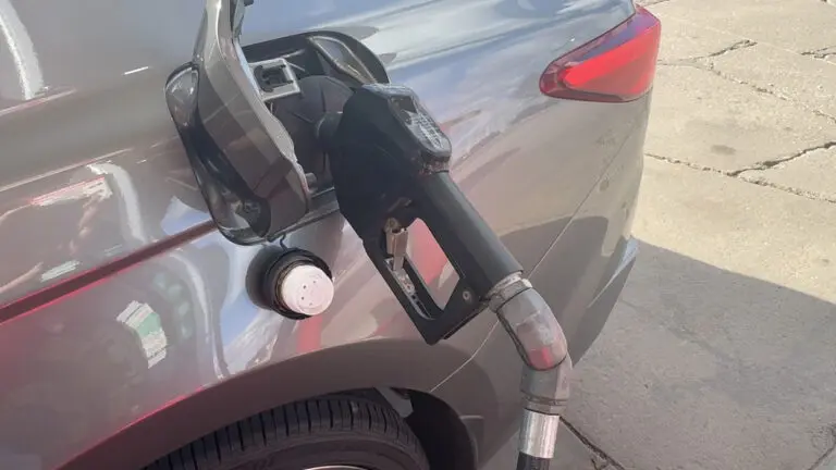 A gas pump rests inside a car's fuel tank at a Naperville gas station