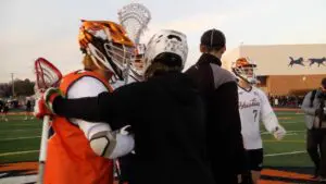 Benet and Naperville North embrace pre-game before an exciting season opener.