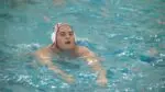 Elliot Skly swims after scoring in victory over Neuqua Valley.