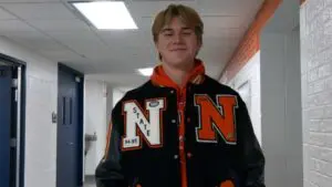 Griffin Jurjovec wears his father's letterman jacket at the 2026 senior Huskie Runway fashion show