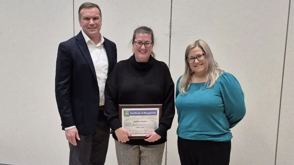 Park board president Brad Wilson, retiring staffer Andrea Coates, and board member Leslie Ruffing.