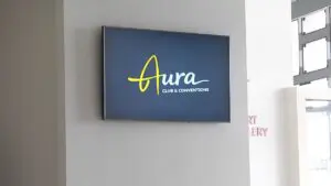 The yellow and white Aura Club and Conventions sign inside the former Matrix Club building.