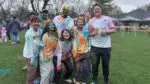 A group of friends covered in chalk pose for a photo at the 16th annual Holi Festival of Colors in Naperville