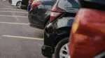 close up of a row of cars parked in a parking lot