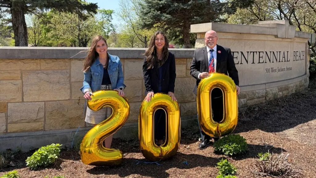 Stacey Fontechia, Atusa Freyer, and Paul Hinterlong, Naperville residents selected to head up the plans for the city’s bicentennial celebration, smile for a picture holding balloons that spell 200.
