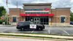 The exterior of a Naperville Bank of America, which was hit with a robbery, with Naperville Police Department car parked in front of the building.