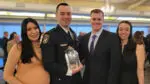 Naperville police officer Peter Pogwizd holds the Pradel Award and stands with the man he rescued, Daniel Forrest, and their wives.