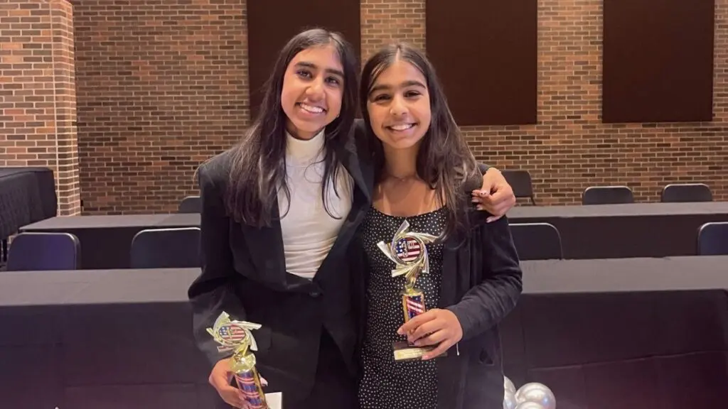 Astha and Reva Savalia pose with trophies from Civics Bee.