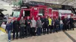 Members of Naperville's fleet services team smile for a picture in front of a fire truck.