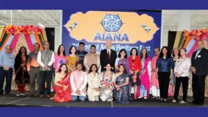 Organizers and dignitaries pose on stage at the AIANA Heritage Fest