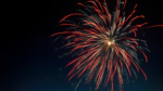 red firework in night sky