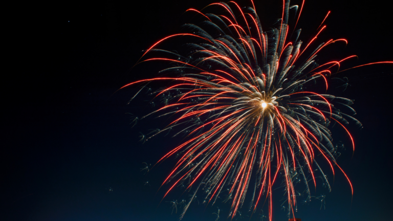 red firework in night sky