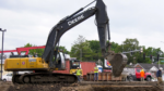 Construction workers use an excavator at North Central College Riverwalk Park.