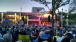 Wide shot of people attending outdoor concert at the MAC at Collelge of DuPage