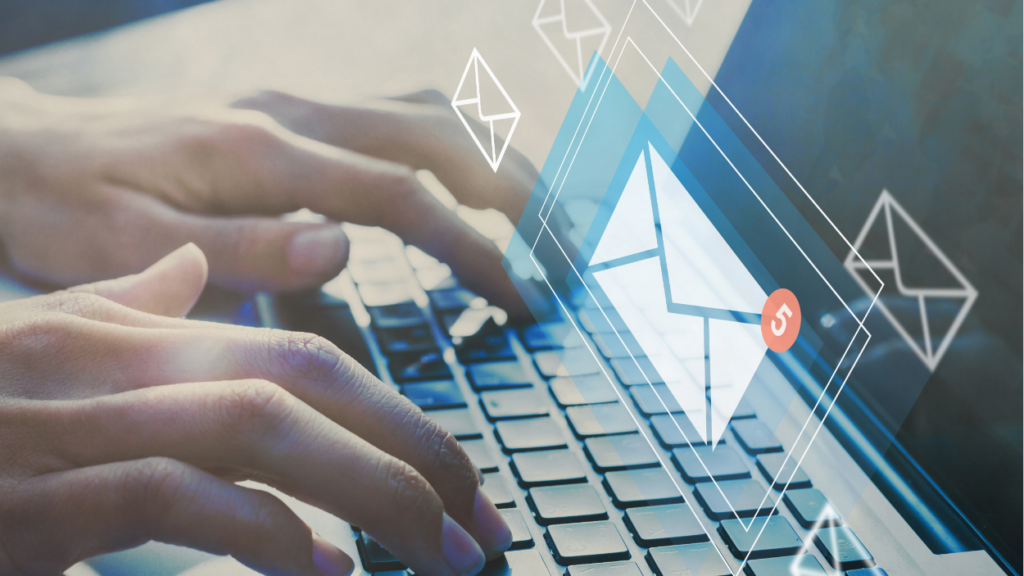 Email icons over person typing on computer