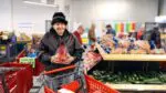 A client of PRC picks out groceries from their market.