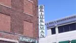 A photo of the green Beidelman Furniture store sign in downtown Naperville.