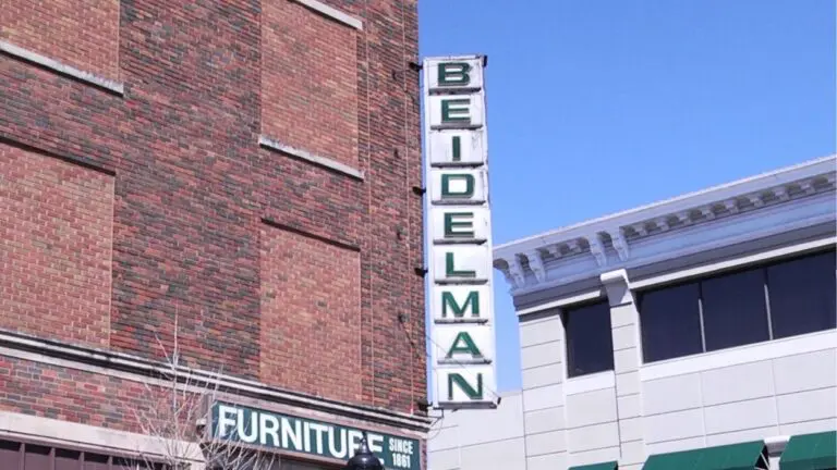 A photo of the green Beidelman Furniture store sign in downtown Naperville.