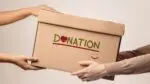 One person handing box labeled Donation to another person