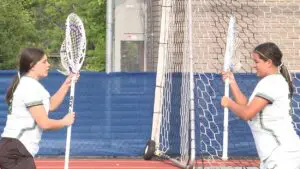 York girls lacrosse netminders prepare for game.