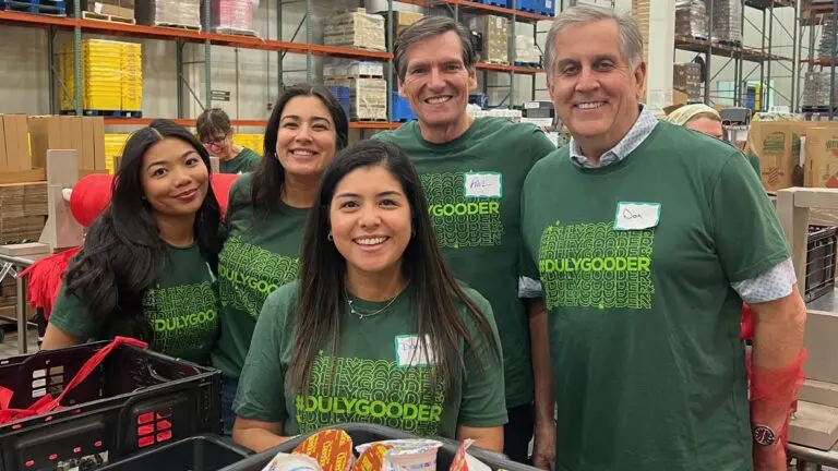 A group of Duly volunteers wearing shirts with #DulyGooder on the front.
