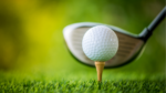 golf club hitting golf ball on tee