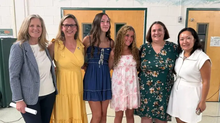 Two Lincoln Junior High School students, two of their teachers and Illinois State Rep. Janet Yang Rohr and State Sen. Laura Ellman smile for a picture together.