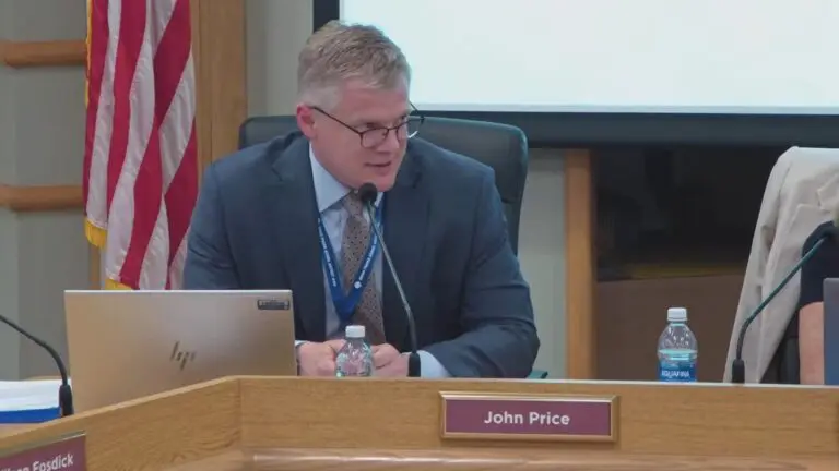 Close up of new IPSD 204 superintendent John Price seated at dais at board meeting