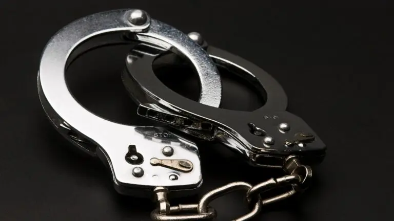 close up of handcuffs against black background