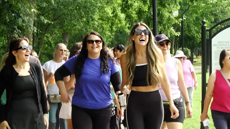 group of women seen smiling and laughing as they participate in a Wave's Women's Walking Community event
